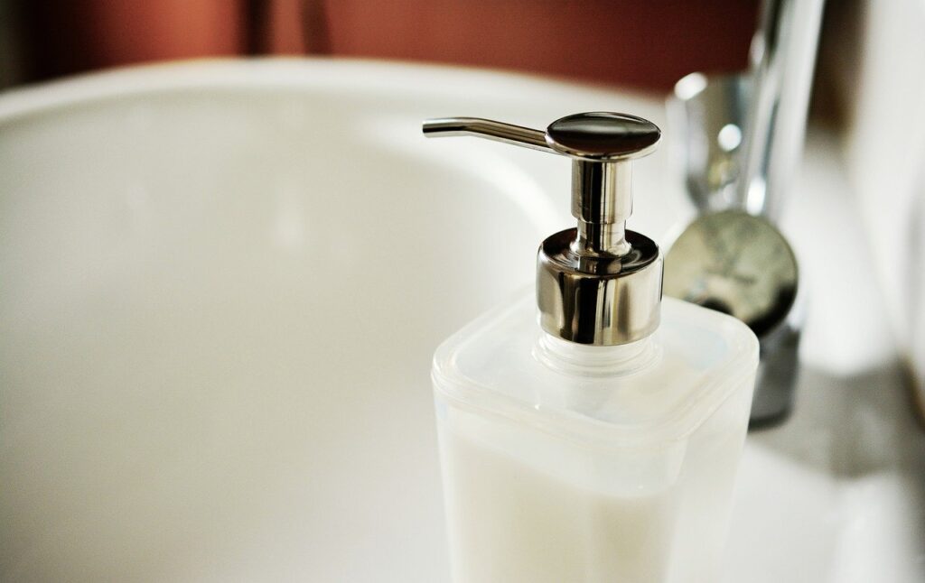 Use Soap Dispenser to decor kitchen faucet.